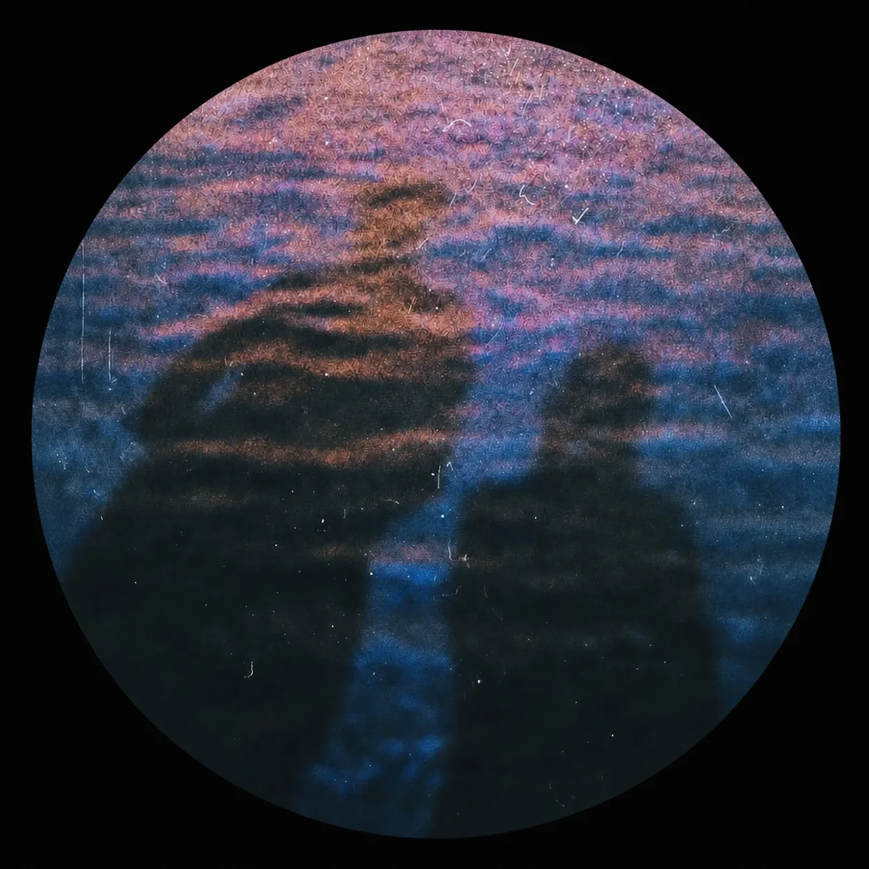 Circular photo of two silhouettes on rippled water at dusk. Bridget In My Room