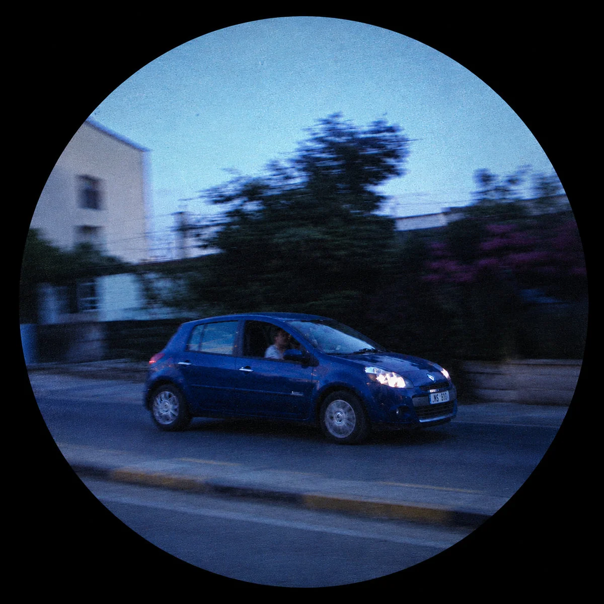 Fisheye photo of a blue car at dusk. j'adore